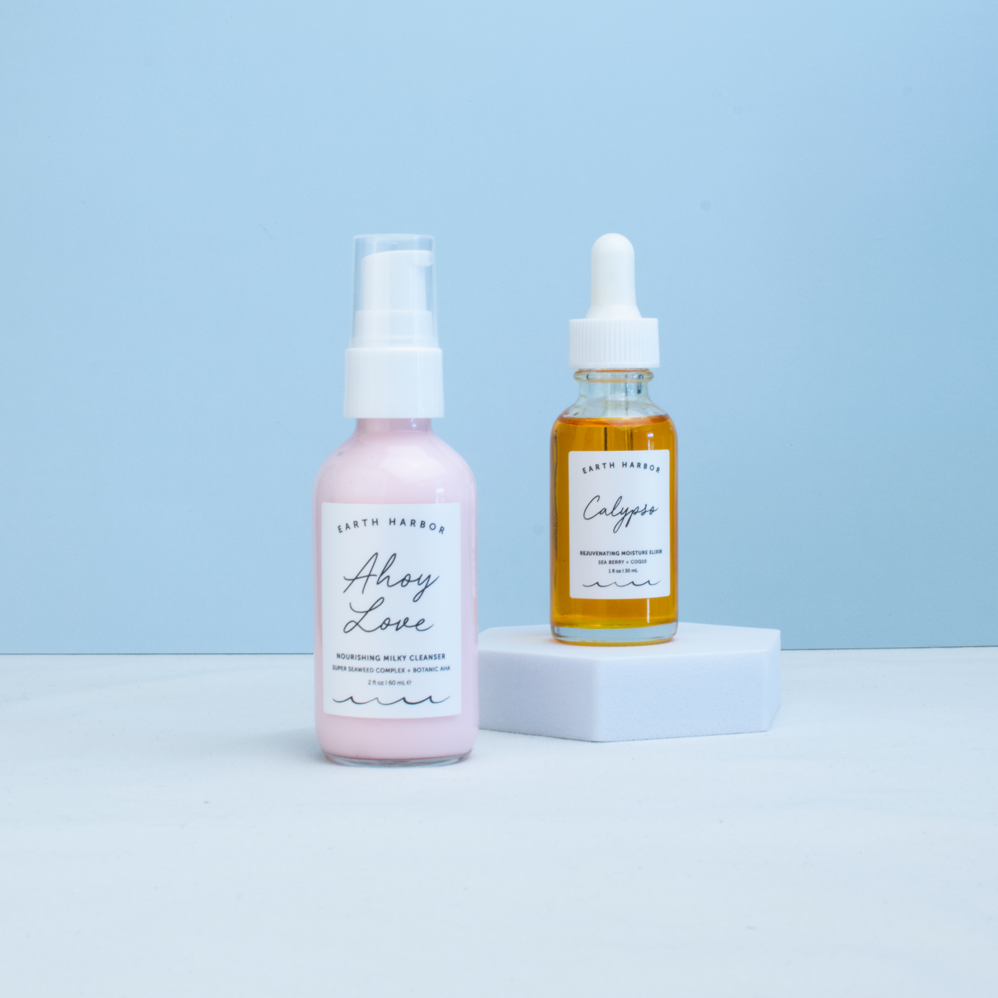 Two bottles of Earth Harbor products on a light blue background